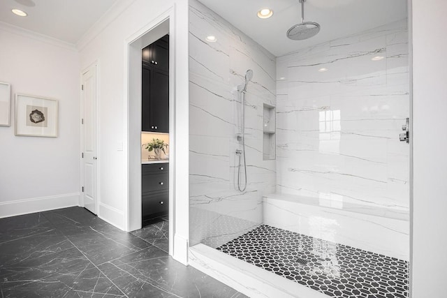 bathroom with tiled shower and ornamental molding