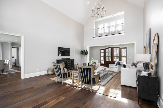 living room with dark hardwood / wood-style flooring, french doors, a high ceiling, and a notable chandelier