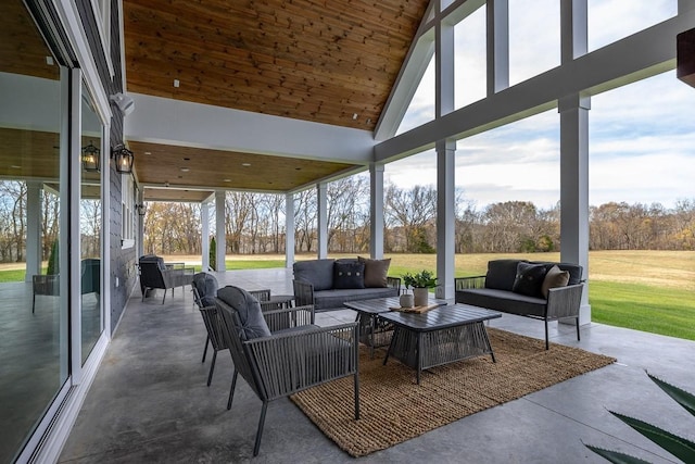 sunroom / solarium featuring a wealth of natural light and lofted ceiling