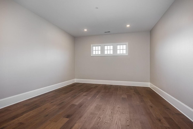 spare room with dark hardwood / wood-style flooring