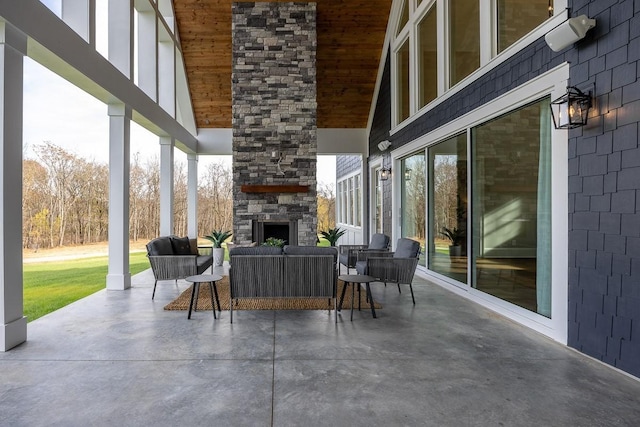 view of patio with an outdoor living space with a fireplace