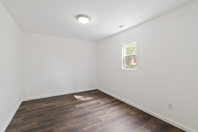 spare room with dark hardwood / wood-style flooring