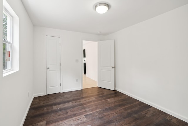 spare room featuring dark hardwood / wood-style floors