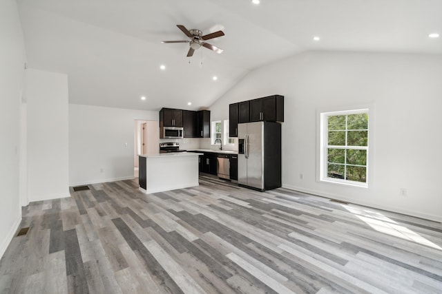 kitchen featuring a center island, sink, ceiling fan, light wood-type flooring, and appliances with stainless steel finishes