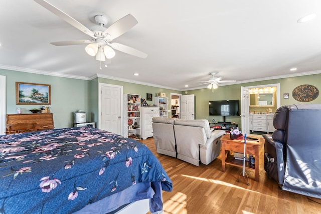 bedroom with ornamental molding, ceiling fan, and light hardwood / wood-style floors