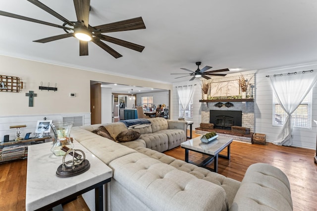 living room with ornamental molding, plenty of natural light, and hardwood / wood-style flooring