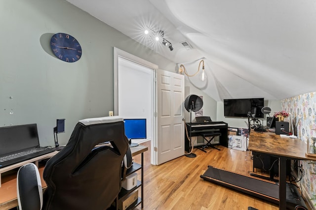 home office featuring light hardwood / wood-style flooring and vaulted ceiling