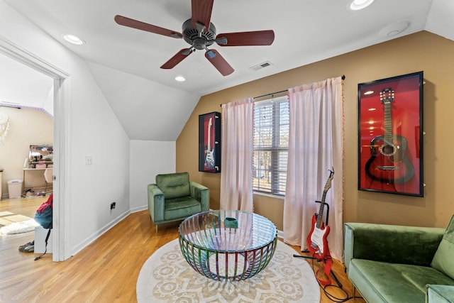 sitting room with ceiling fan, light hardwood / wood-style flooring, and lofted ceiling