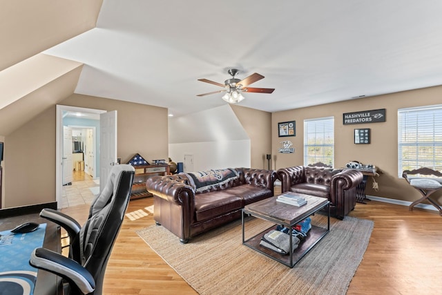 living room with lofted ceiling, ceiling fan, and light hardwood / wood-style floors