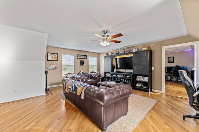 living room with light wood-type flooring and ceiling fan