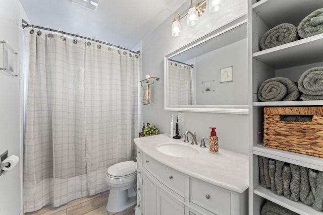 full bathroom with shower / tub combo, hardwood / wood-style floors, vanity, and toilet