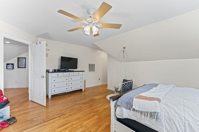 bedroom with ceiling fan, light wood-type flooring, and lofted ceiling