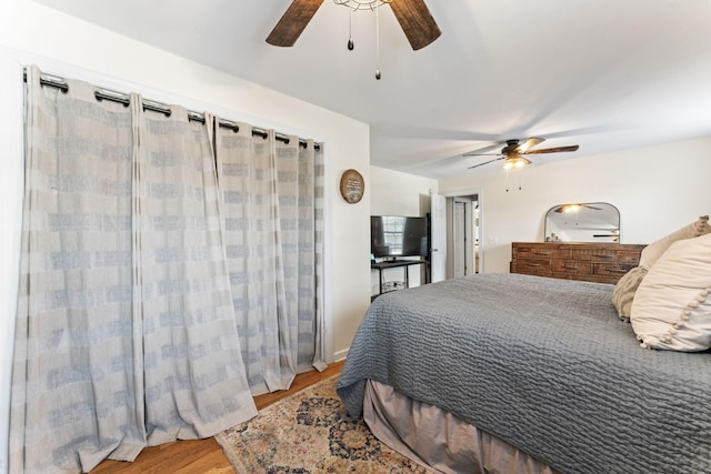 bedroom with ceiling fan and hardwood / wood-style floors