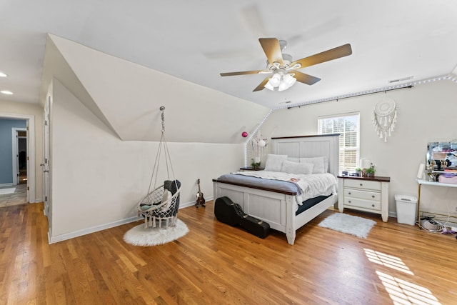 bedroom with vaulted ceiling, ceiling fan, and light hardwood / wood-style floors