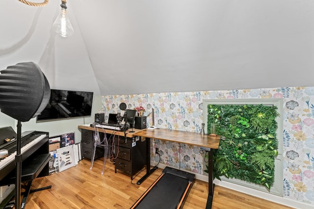 home office featuring light wood-type flooring and vaulted ceiling