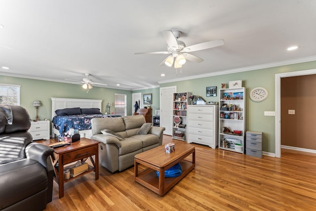 living room featuring light wood-type flooring, ceiling fan, and crown molding