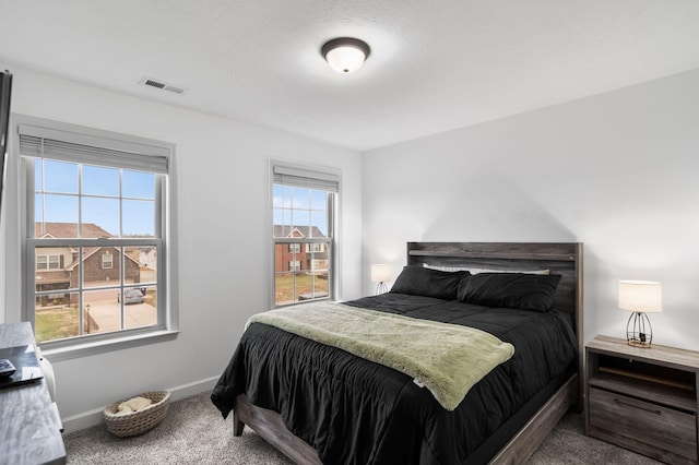 carpeted bedroom featuring multiple windows