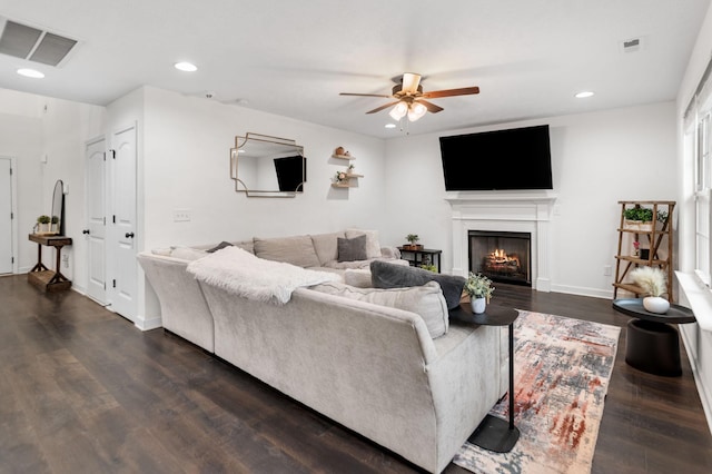 living room with ceiling fan and dark hardwood / wood-style flooring