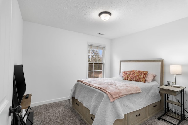 bedroom with carpet and a textured ceiling