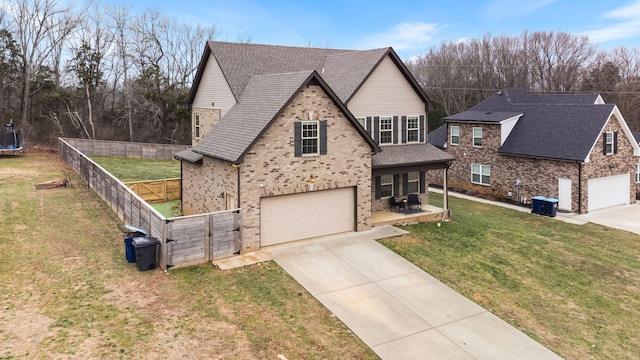 view of front of house featuring a garage and a front lawn