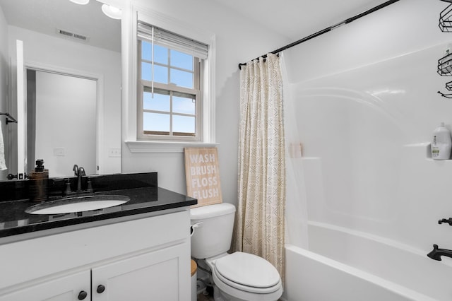 full bathroom with vanity, shower / bath combination with curtain, and toilet