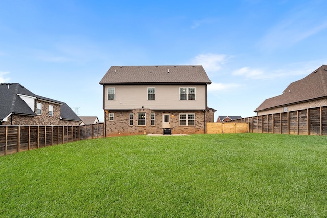 rear view of house with a yard