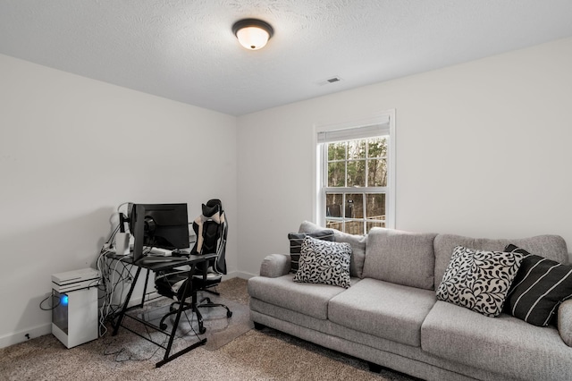 home office featuring carpet flooring and a textured ceiling