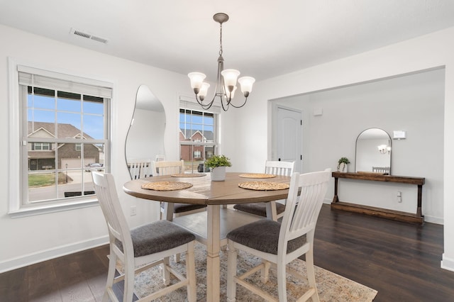 dining area with a chandelier and dark hardwood / wood-style floors