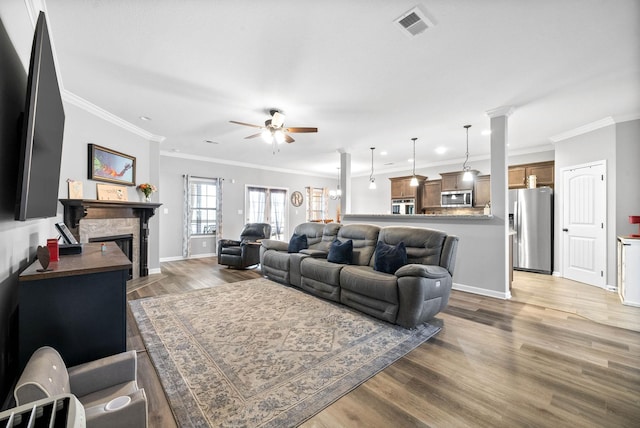 living room featuring ceiling fan, crown molding, and dark hardwood / wood-style floors