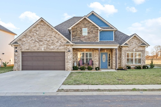 craftsman-style home featuring covered porch, a front lawn, and a garage