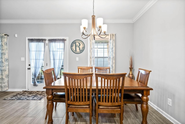 dining area featuring a chandelier, hardwood / wood-style flooring, and ornamental molding