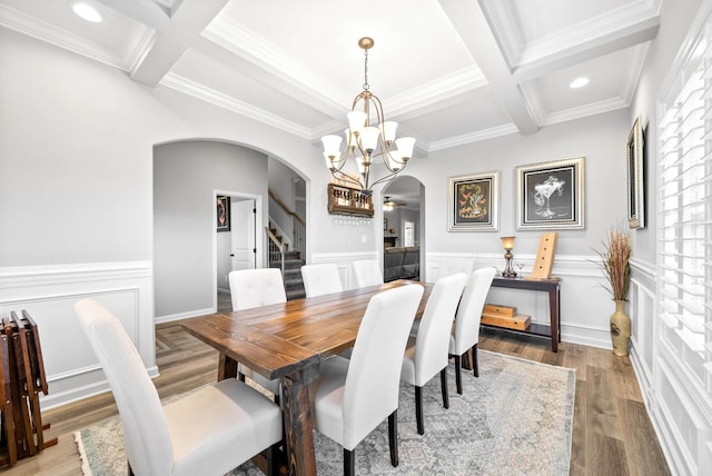 dining space with beam ceiling, coffered ceiling, and wood-type flooring