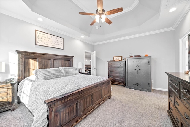 carpeted bedroom featuring ceiling fan, crown molding, and a tray ceiling