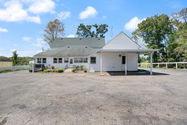 back of property featuring a carport and central AC unit