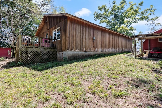 view of home's exterior featuring a yard and a deck