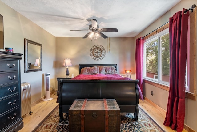 bedroom featuring ceiling fan and light hardwood / wood-style floors