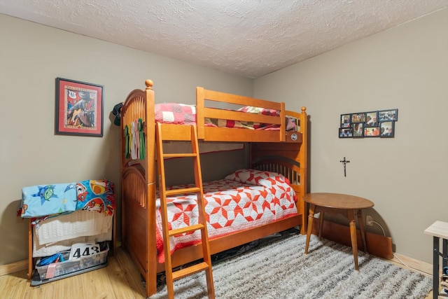 bedroom with wood-type flooring and a textured ceiling