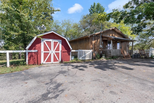 view of outbuilding featuring covered porch