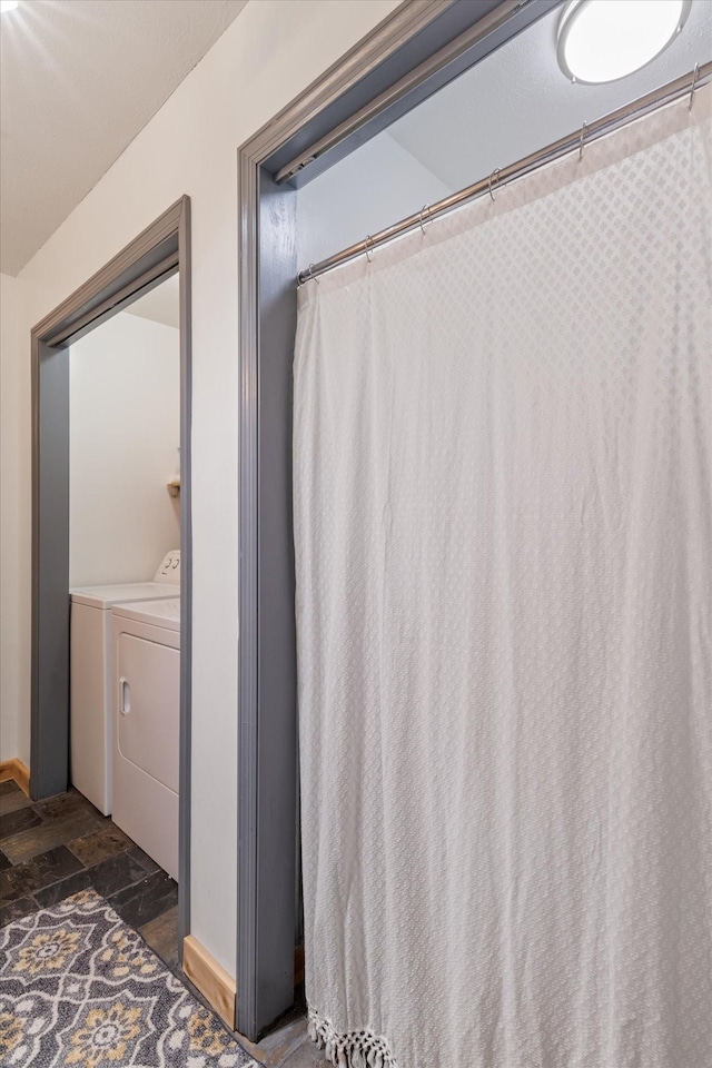 bathroom featuring washer and clothes dryer