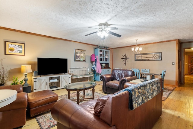 living room featuring a textured ceiling, light hardwood / wood-style floors, and crown molding