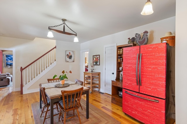 dining space with hardwood / wood-style flooring