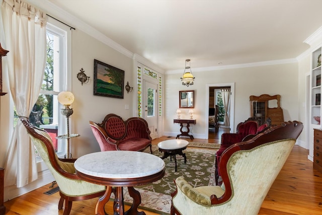 living room featuring light wood-type flooring and ornamental molding