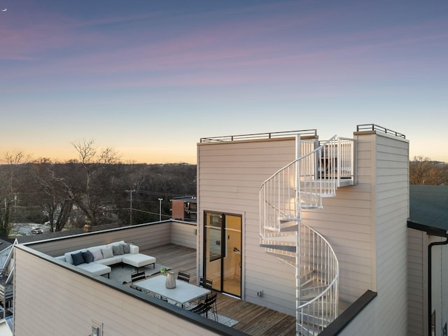 deck at dusk featuring an outdoor hangout area