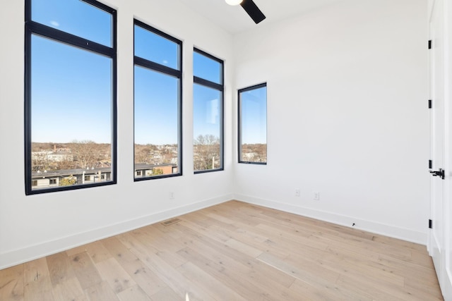 empty room featuring ceiling fan and light hardwood / wood-style flooring