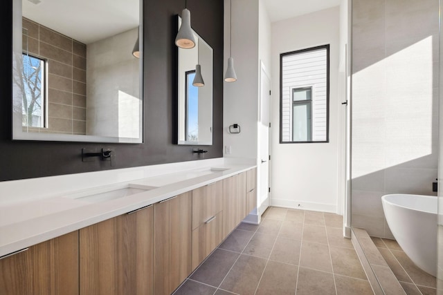 bathroom featuring tile patterned floors, a tub to relax in, and vanity