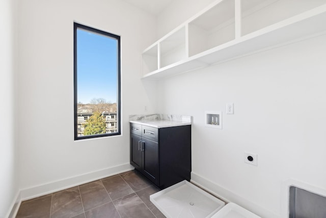 clothes washing area with washer hookup, dark tile patterned flooring, and electric dryer hookup