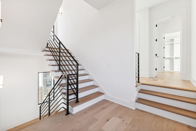 staircase with hardwood / wood-style flooring