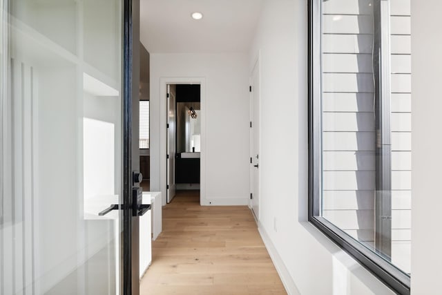 hall with light hardwood / wood-style flooring