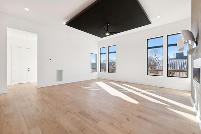 unfurnished room with ceiling fan and light hardwood / wood-style floors