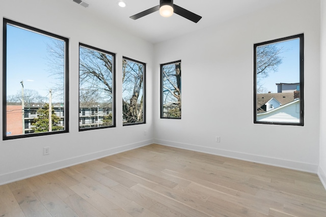 spare room featuring ceiling fan and light hardwood / wood-style floors